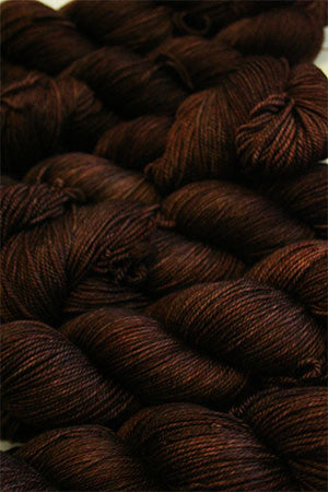 Fingering weight yarn from Zen Yarn Garden's Serenity 20 collection in a warm, rich chestnut color, displayed in skein form.