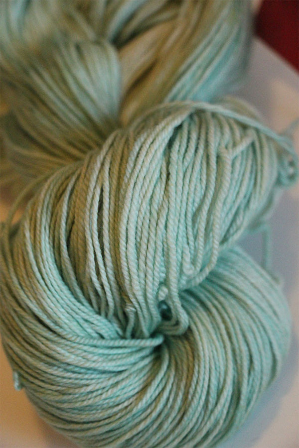 Fingering weight yarn by Zen Yarn Garden in vibrant African jade color, showcasing soft, high-quality Zen Yarn Garden Serenity 20.