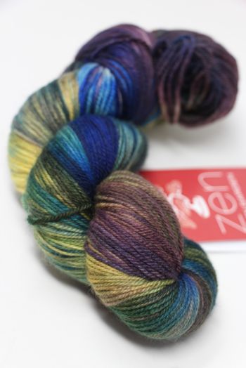 Fingering weight yarn from Zen Yarn Garden's Serenity 20 collection in iris purple, showcasing soft, variegated fiber texture.