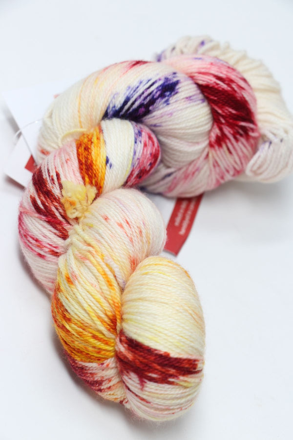 Fingering weight yarn Zen Yarn Garden Serenity 20 in a vibrant, multicolored skein with rich, variegated hues for knitting or crochet projects.