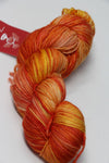 Fingering weight yarn from Zen Yarn Garden's Serenity 20 collection in a vibrant, crush-colored skein with soft, textured fibers.