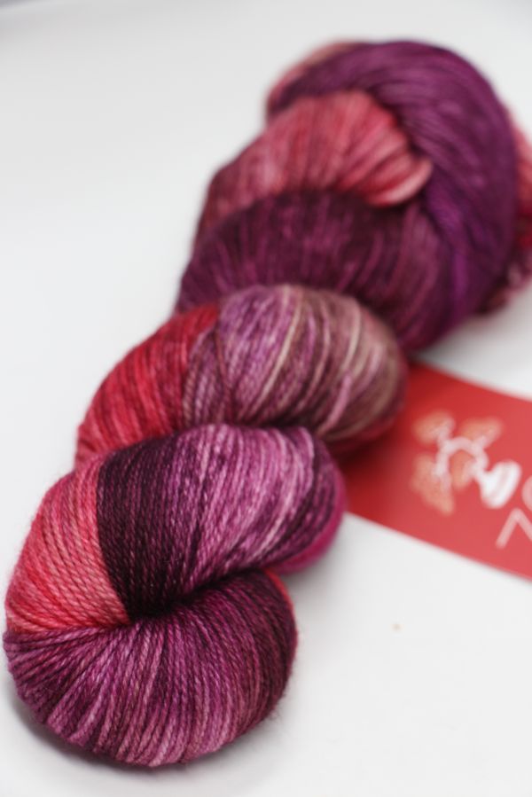 Fingering weight yarn from Zen Yarn Garden's Serenity 20 collection in soft, variegated shades, displayed in a close-up shot.