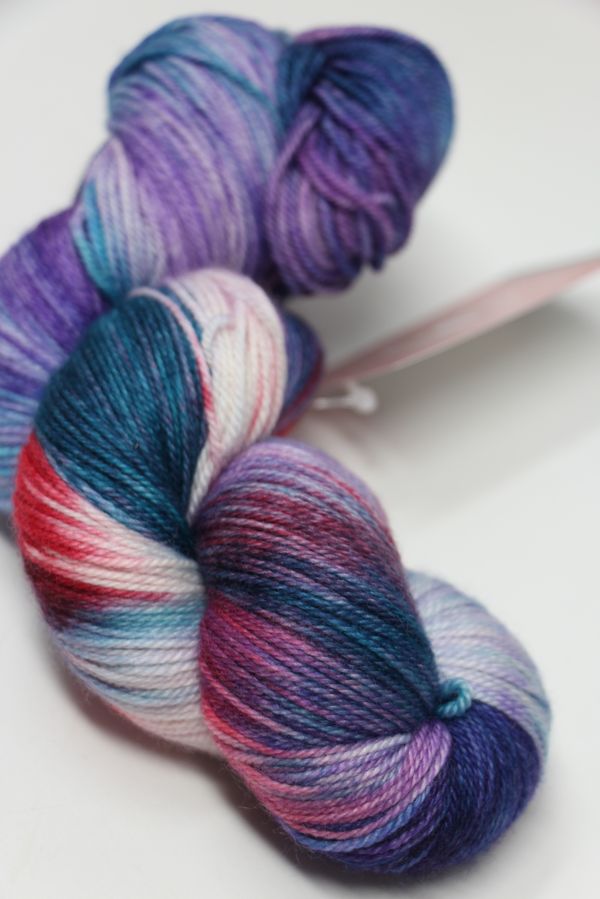 Fingering weight yarn from Zen Yarn Garden's Serenity 20 collection, with a pastel paisley pattern in soft colors.
