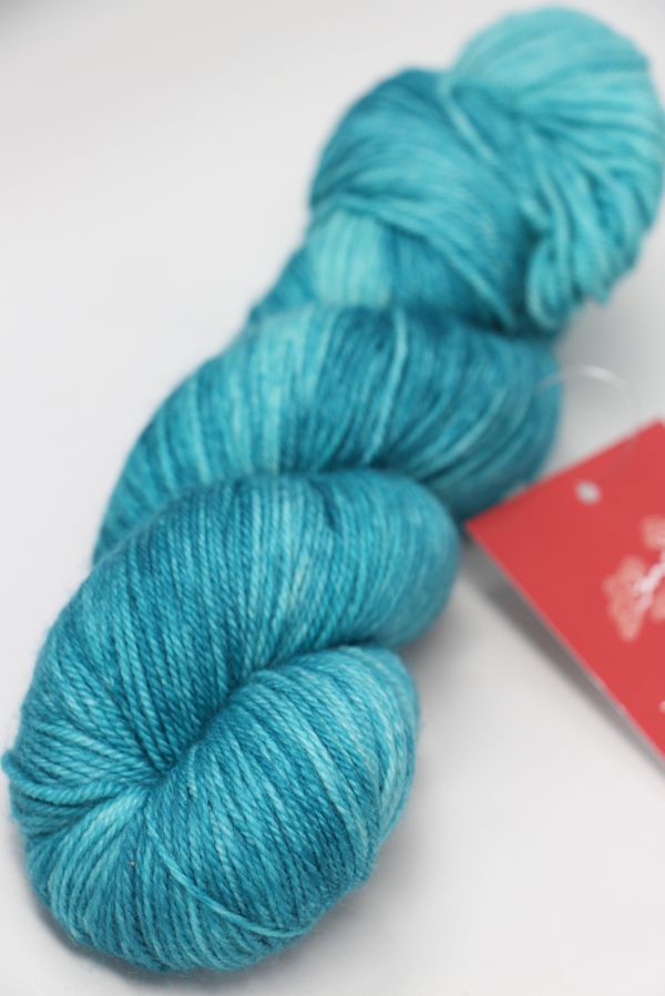 Fingering weight yarn from Zen Yarn Garden's Serenity 20 collection, featuring soft, variegated mint green and gray tones.