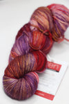 Fingering weight yarn from Zen Yarn Garden's Serenity 20 collection in mermaid colorway, displayed in a skein with vibrant hues.
