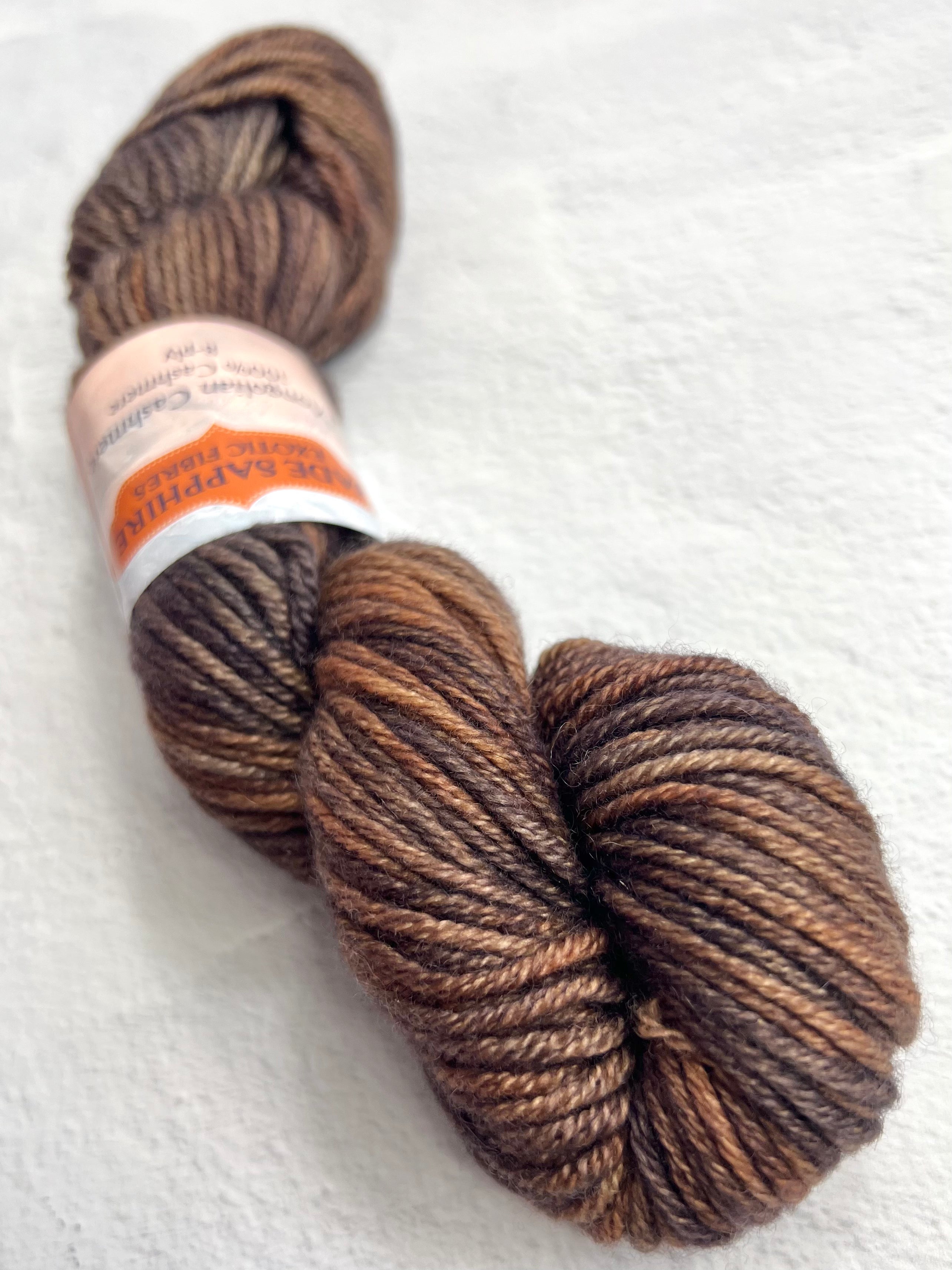 Jade Sapphire Cashmere 8 Ply Cashmere Yarn in shades of brown, showcasing soft, luxurious yarn strands for knitting or knitting projects.
