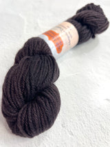 Black Jade Sapphire 8 Ply Cashmere Yarn ball showing soft, luxurious cashmere fibers in a smooth, tightly wound bundle.