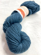 Deep denim blue Jade Sapphire Cashmere 8 ply cashmere yarn spool showcasing soft, luxurious fiber for knitting and knitting projects.