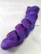 Close-up of Artyarns Regal Silk Yarn H Series, showcasing vibrant silk fiber with shiny, textured highlights for knitting or crochet projects.