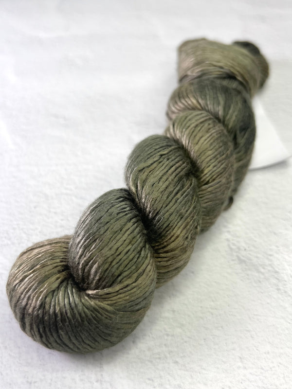 Close-up of Artyarns Regal Silk Yarn H Series with vibrant silk fibers and rich, glossy texture in a natural skein.