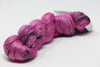 Colorful skein of Artyarns Ensemble Light yarn from the Cosmic Colors series, showcasing vibrant, multi-hued fiber for knitting or crochet.