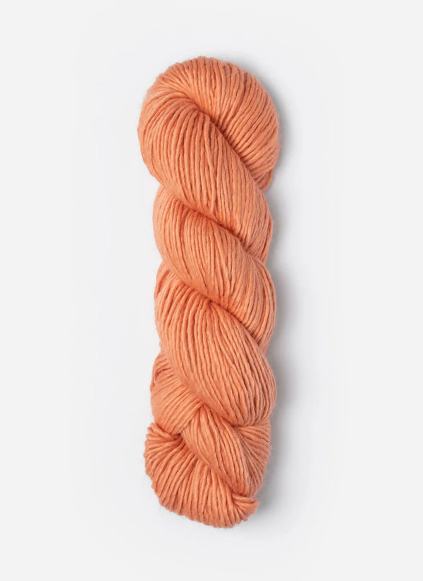 Blue Sky Fibers Suri Merino alpaca and merino yarn in a soft blue color, showcasing a close-up of the fiber texture.