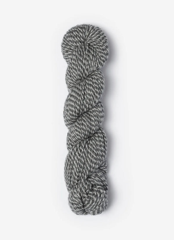 Blue Sky Fibers Baby Alpaca Sport Weight Melange alpaca yarn in soft blue and cream tones, showcasing the textured yarn strands.
