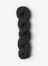 Blue Sky Fibers Baby Alpaca Sport Weight Melange alpaca yarn skein in soft blue and gray tones with label visible.