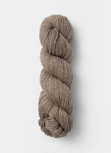 Blue Sky Fibers Sweater Worsted Superwash knitting yarn in blue, showing the soft, smooth wool and cotton blend fibers.