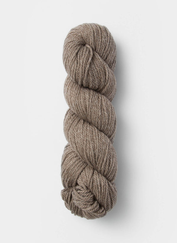 Blue Sky Fibers Sweater Worsted Superwash knitting yarn in blue, showing the soft, smooth wool and cotton blend fibers.