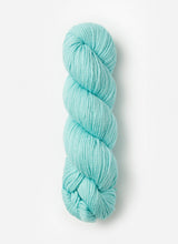 Blue Sky Fibers Sweater Worsted Superwash knitting yarn in blue, showing soft wool and cotton blend fibers for cozy projects.