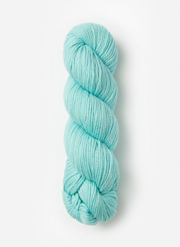 Blue Sky Fibers Sweater Worsted Superwash knitting yarn in blue, showing soft wool and cotton blend fibers for cozy projects.
