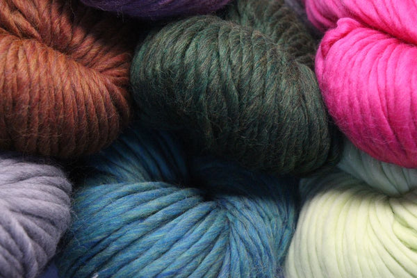 Cascade Yarns Magnum bulky yarn ball in vibrant colors, showcasing its thick, cozy texture perfect for warm knitting projects.