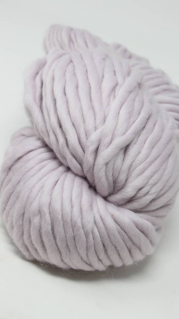 Cascade Yarns Magnum bulky yarn in orchid color, showing thick, soft yarn skein with vibrant purple hue.