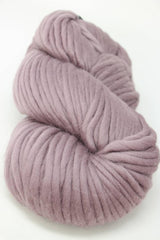 Cascade Yarns Magnum bulky yarn in elderberry purple, showing thick, textured skein suitable for cozy knitting projects.