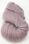 Cascade Yarns Magnum bulky yarn in elderberry purple, showing thick, textured skein suitable for cozy knitting projects.
