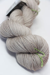 Close-up of madelinetosh Vintage merino wool yarn in antique lace color, showcasing its soft texture and rich hue.
