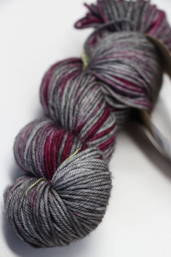 Black Madeline Tosh Vintage Merino Wool Yarn skein, soft and textured, perfect for knitting or crocheting projects.