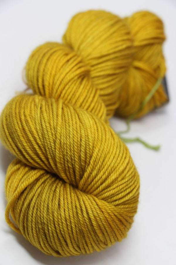 MadelineTosh Vintage Merino Wool Yarn in Candlewick color, soft and textured skein for knitting and crochet projects.