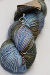 Madeline Tosh Vintage Merino Wool Yarn in Mala color, showing soft, textured yarn with vibrant blue and green hues.