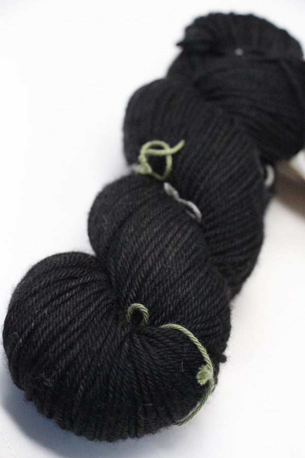 MadelineTosh vintage merino wool yarn in onyx black, showcasing soft, high-quality yarn with subtle color variations.