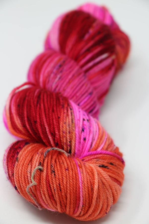 Madeline Tosh Vintage Merino Wool Yarn in Mars In Retrograde color, showing soft, textured yarn with vibrant maroon and purple hues.