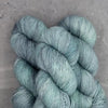 MadelineTosh VINTAGE merino wool yarn in Celadon color, showing soft, textured skein ideal for knitting or crochet projects.