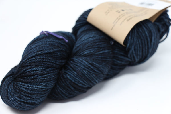 Soft, hand-dyed Madelinetosh Tosh DK yarn in Dubrovnik colorway, showcasing its rich, vibrant blue and purple tones.