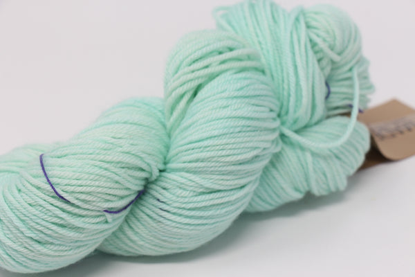Madelinetosh Tosh DK yarn in Havana colorway, soft wool blend with rich, warm brown hues and subtle color variations.