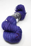 Madelinetosh Tosh DK yarn in Iris colorway, soft wool blend with vibrant purple and pink tones, displayed in a close-up shot.