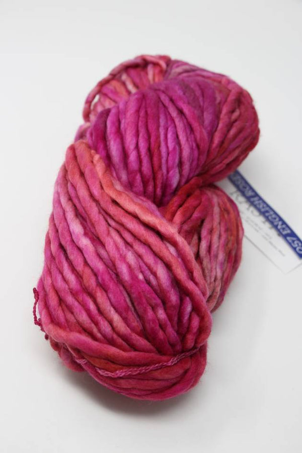 Malabrigo Rasta merino wool yarn in English Rose color, showing soft, thick, and textured yarn fibers.