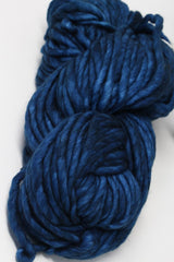 Malabrigo Rasta merino wool yarn in deep blue, showing thick, soft, hand-dyed fiber ideal for knitting and crochet projects.