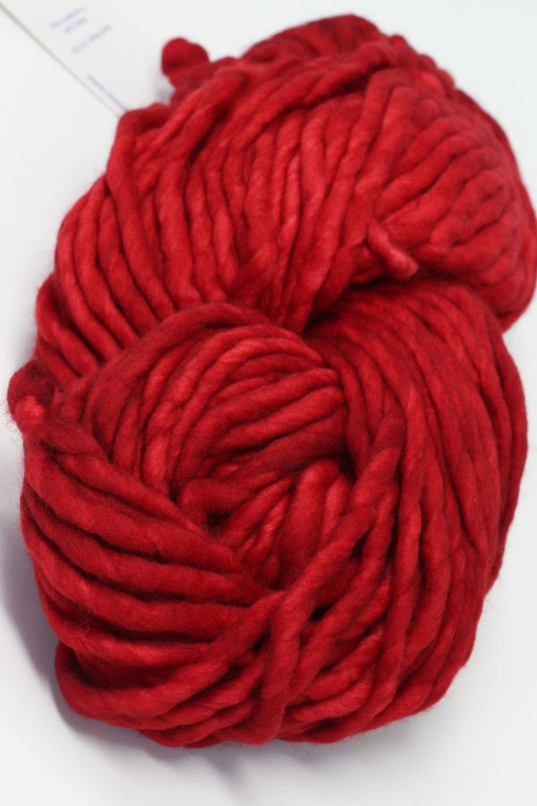 Malabrigo Rasta merino wool yarn in Ravelry Red, soft and vibrant yarn for knitting and crochet projects.