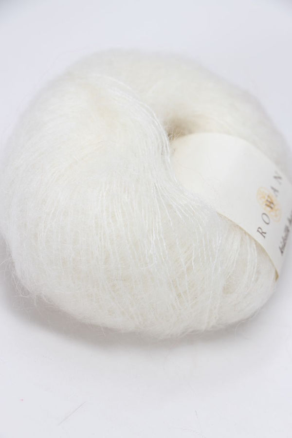 Cream-colored Rowan Kidsilk Haze yarn ball, soft and lightweight, suitable for knitting and crochet projects.