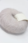 Soft Rowan Kidsilk Haze yarn in pearl color, showing delicate, lightweight silk and mohair fibers ideal for knitting or crochet projects.