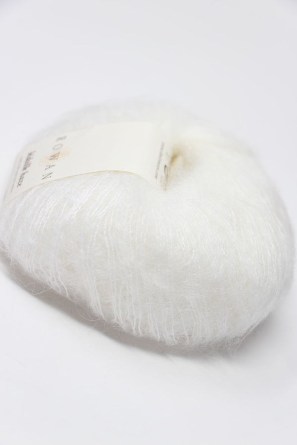 White Rowan Kidsilk Haze yarn ball, soft and delicate, showcasing the fine, lightweight fibers of Rowan's knitting yarn.