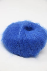 Blue Rowan Kidsilk Haze yarn ball with soft, fuzzy texture and colorful fiber blending, ideal for knitting and crochet projects.