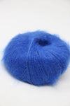 Blue Rowan Kidsilk Haze yarn ball with soft, fuzzy texture and colorful fiber blending, ideal for knitting and crochet projects.
