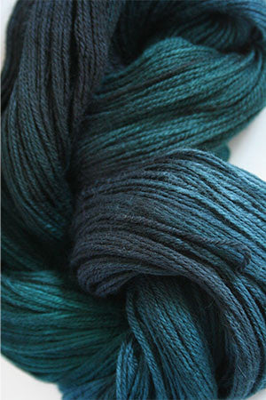 Close-up of Artyarns Merino Cloud Yarn H Series in soft, variegated pink and gray shades, showcasing its fluffy, textured fiber.