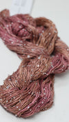 Artyarns Beaded Silk & Sequins Light beaded yarn with shimmering sequins and silk fibers, shown in a close-up view.