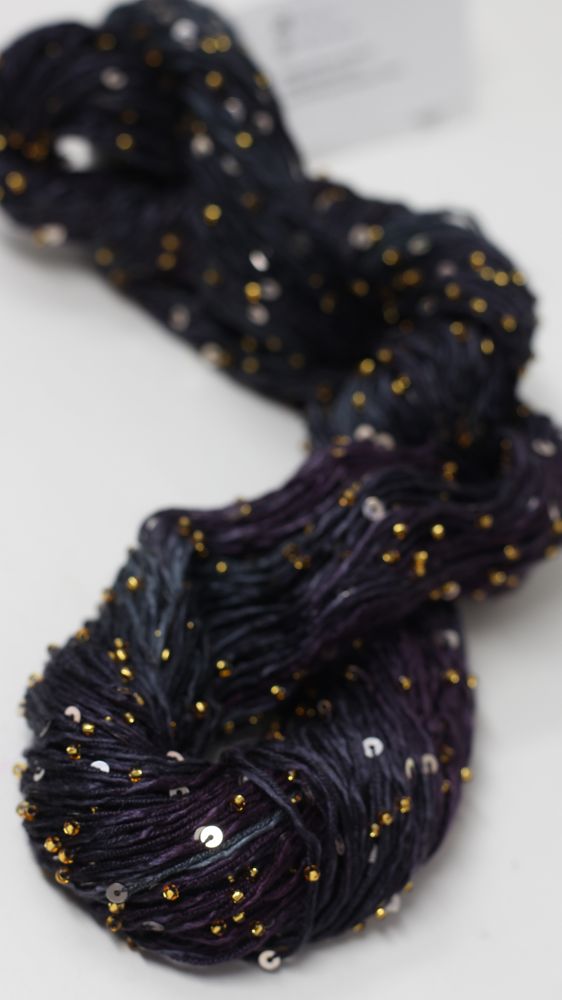 Beaded silk and sequins yarn by Artyarns, showcasing shimmering beads and delicate silk fibers in a vibrant color.