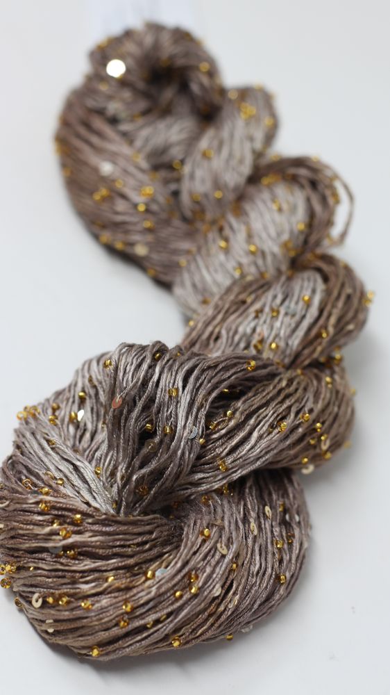 Beaded silk yarn with sequins from Artyarns Beaded Silk & Sequins Light H Series, featuring shiny beads and luxurious silk fibers.