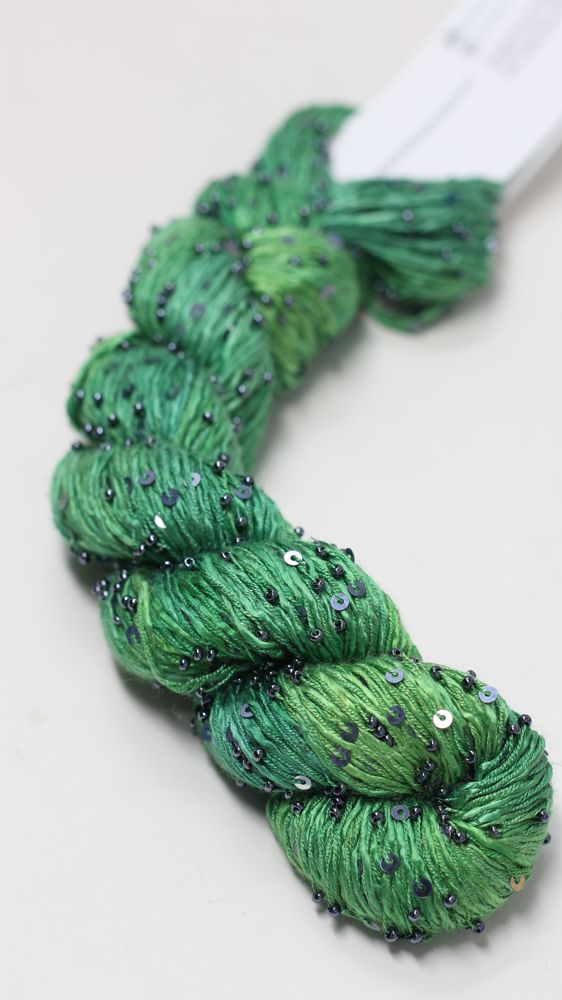 Beaded silk and sequins yarn from Artyarns' Beaded Silk & Sequins Light series, close-up of shimmering beaded fiber with sequins.