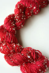 Beaded silk and sequins yarn from Artyarns' Beaded Silk & Sequins Light H Series, featuring shiny beads and sequins on soft yarn.